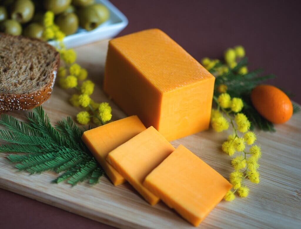 Organic Sharp Cheddar Cheese on a Cutting Board