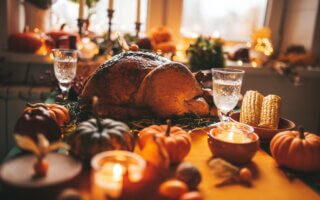 Thanksgiving holiday dinner table setting with fall decoration and pumpkins