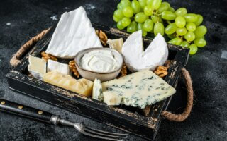 Assorted Cheese platter with Brie, Camembert, Roquefort, parmesan, blue cream cheese, grape