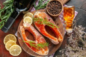 top view fish slices with bottle of wine on the dark-red background food color seafood meat meal